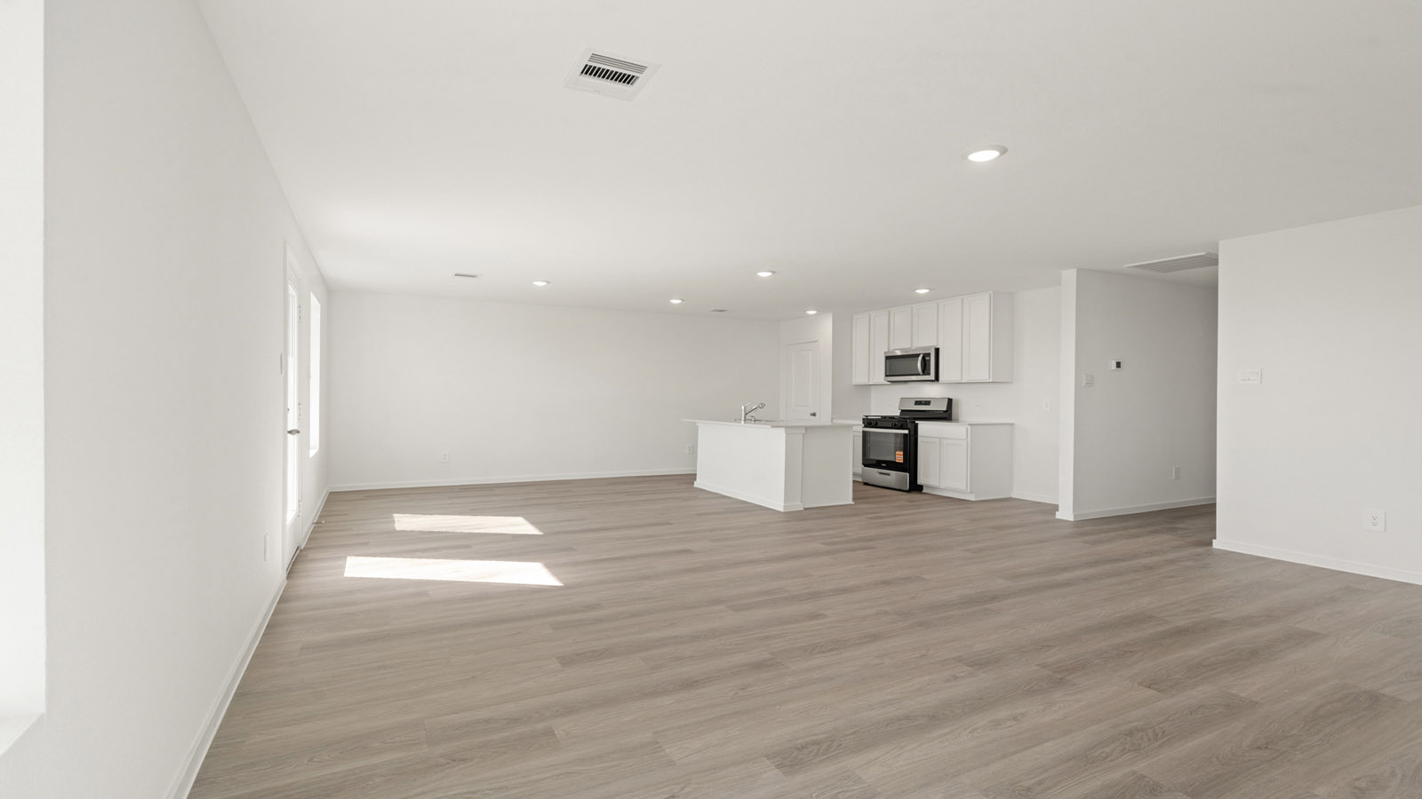 open concept living and dining area with vinyl flooring