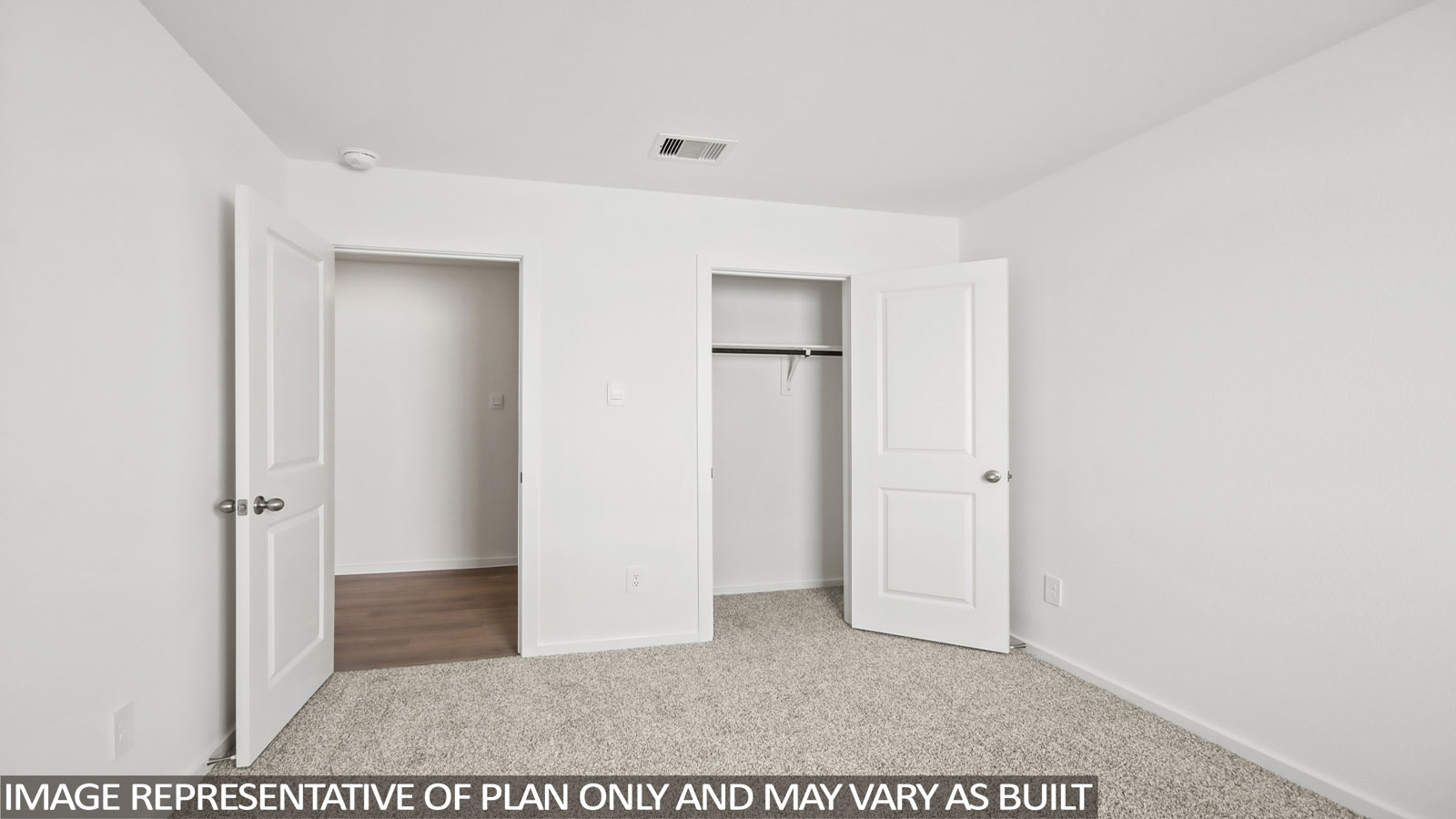 Secondary bedroom with carpet flooring