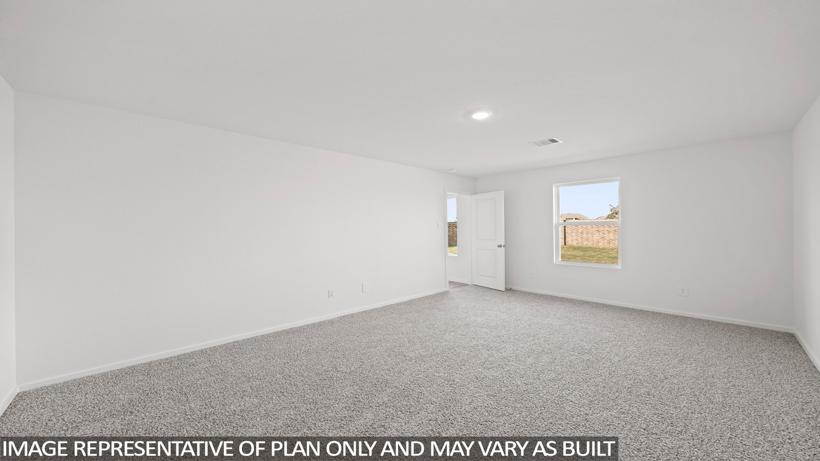 Primary bedroom with carpet flooring