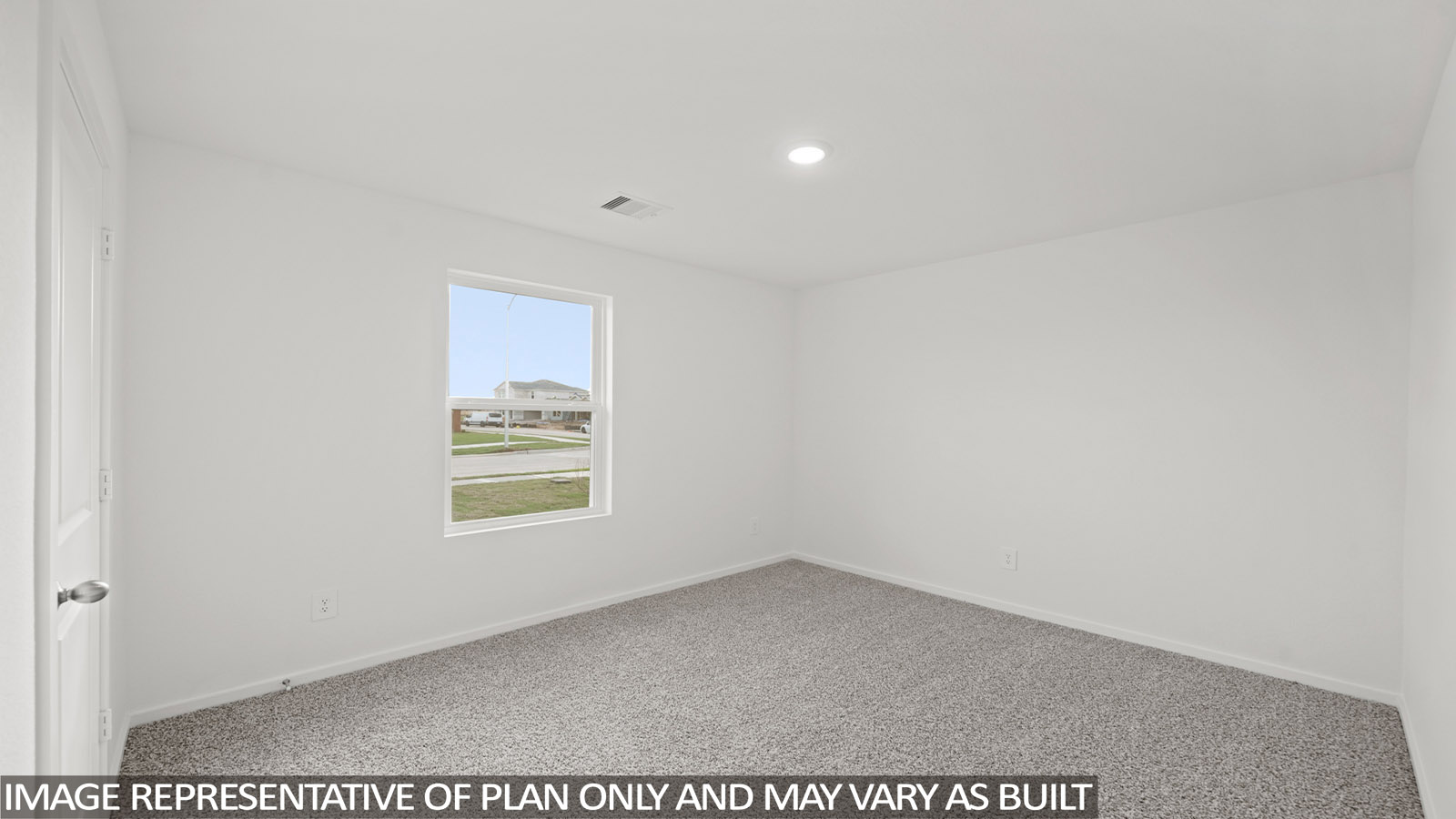 Secondary bedroom with carpet flooring