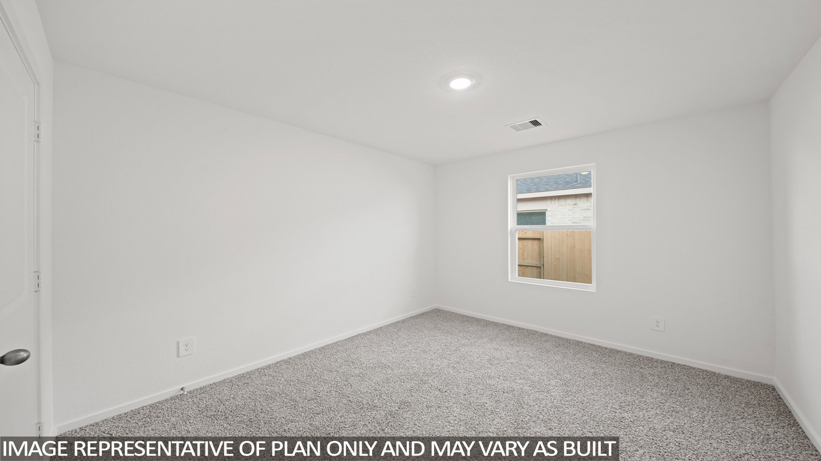 Secondary bedroom with carpet flooring