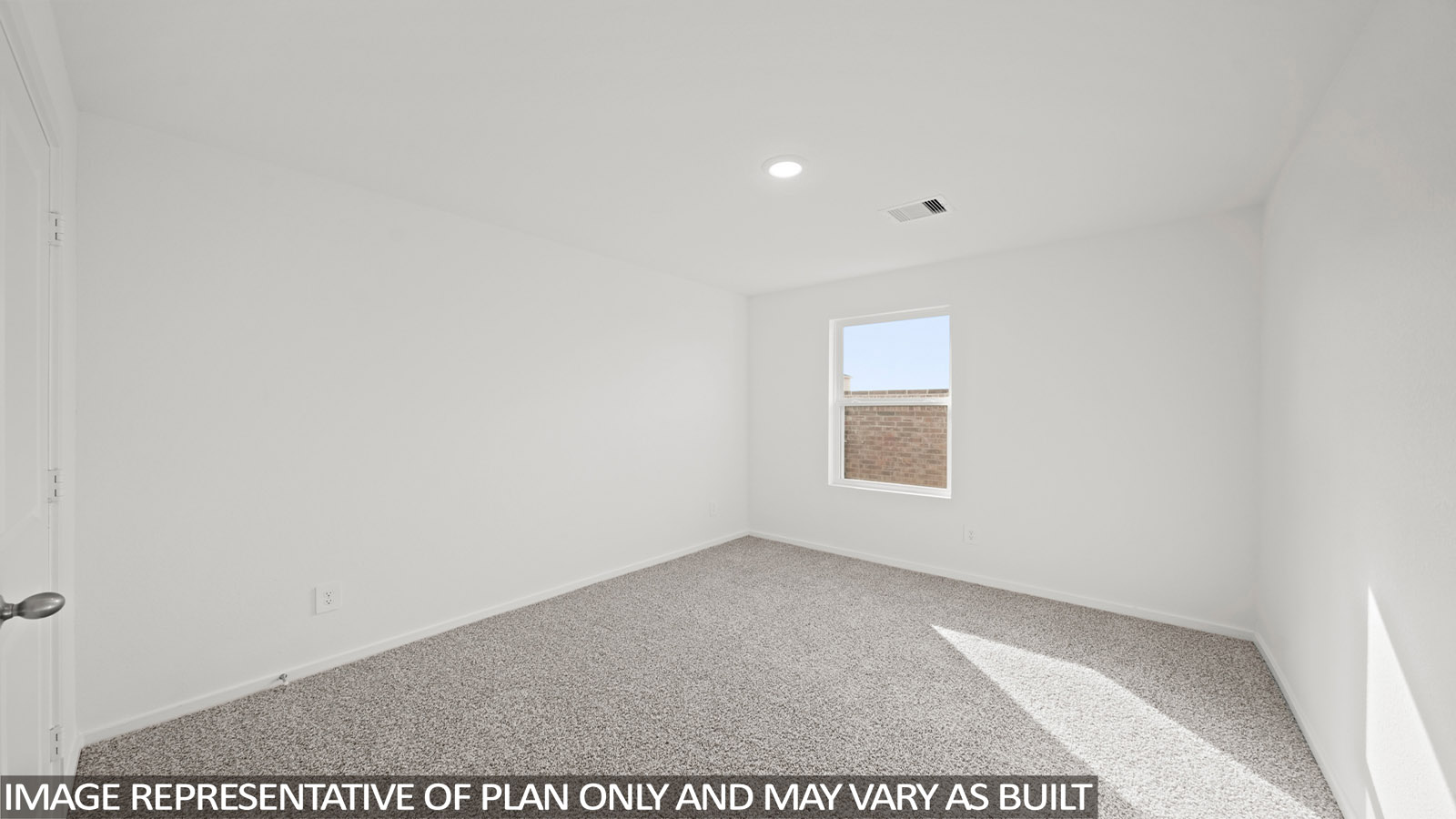 Secondary bedroom with carpet flooring