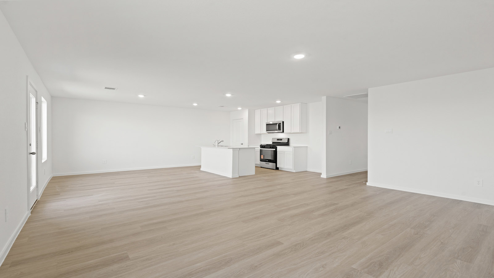 open concept living and dining area with vinyl flooring, quartz countertops, and large windows