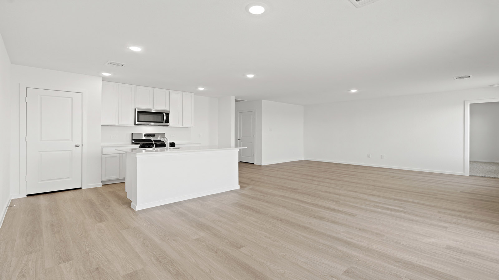 open concept living and dining area with vinyl flooring, quartz countertops, and large windows