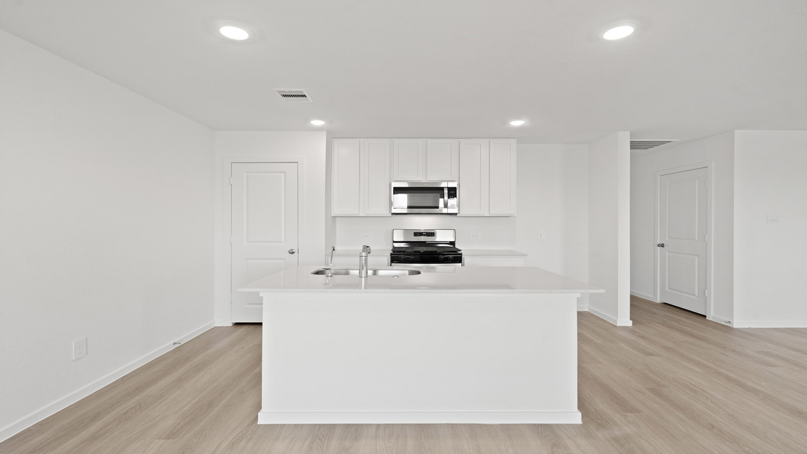 open concept living and dining area with vinyl flooring, quartz countertops, and large windows