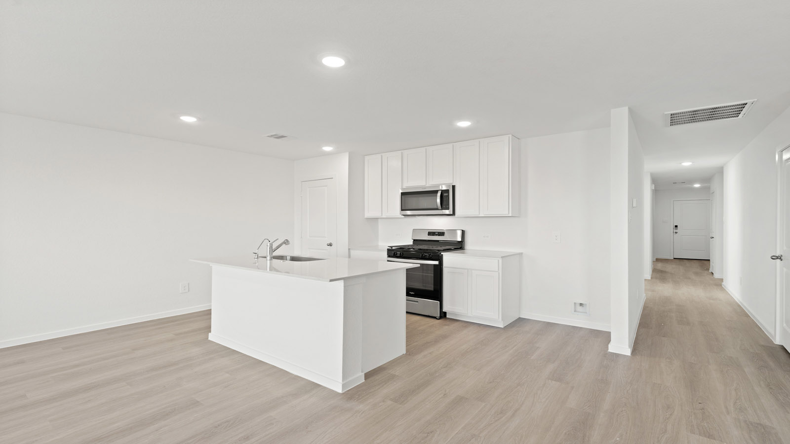 open concept living and dining area with vinyl flooring, quartz countertops, and large windows