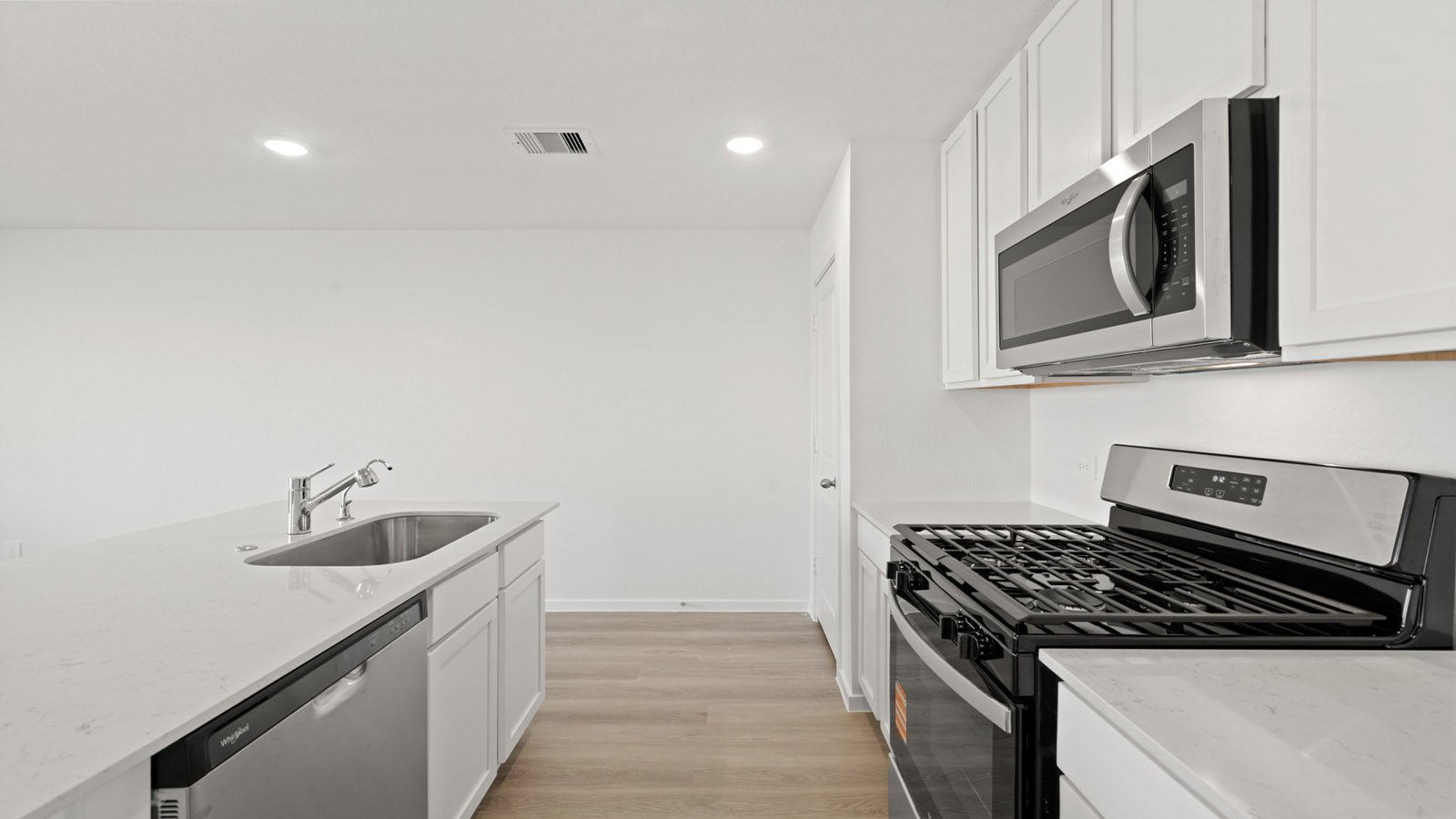 open concept living and dining area with vinyl flooring, quartz countertops, and large windows