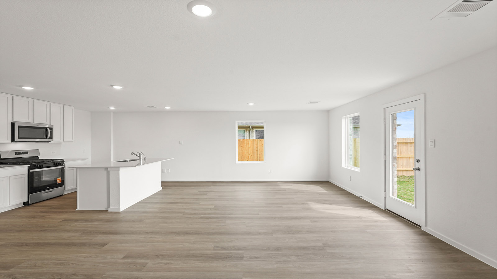 Spacious living area with vinyl flooring