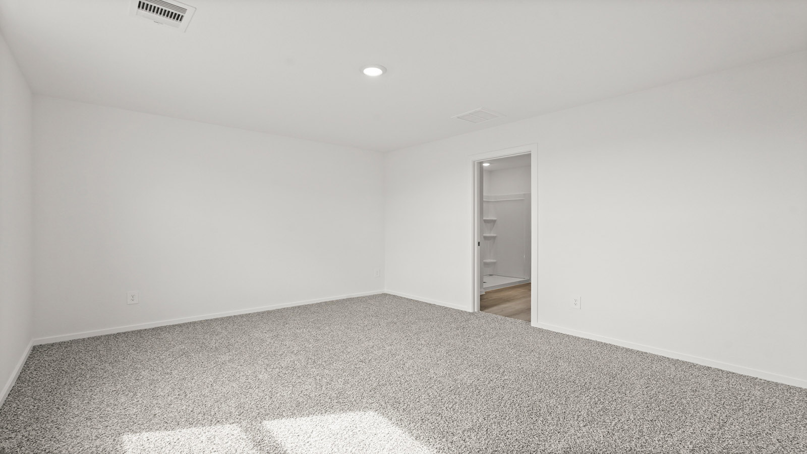 Primary bedroom with carpet flooring