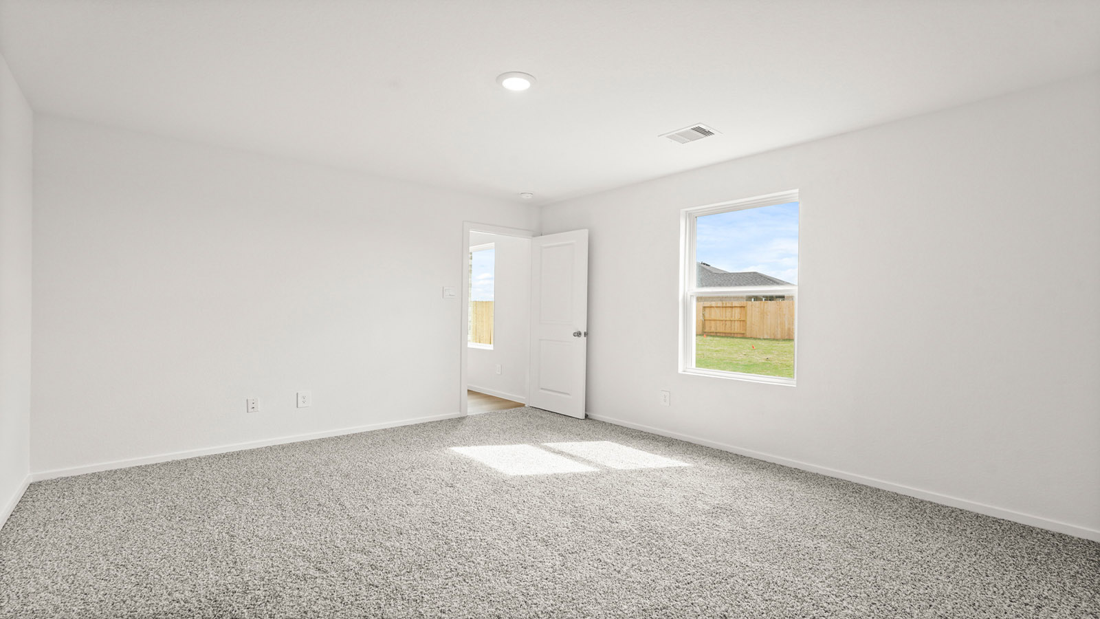 Primary bedroom with carpet flooring