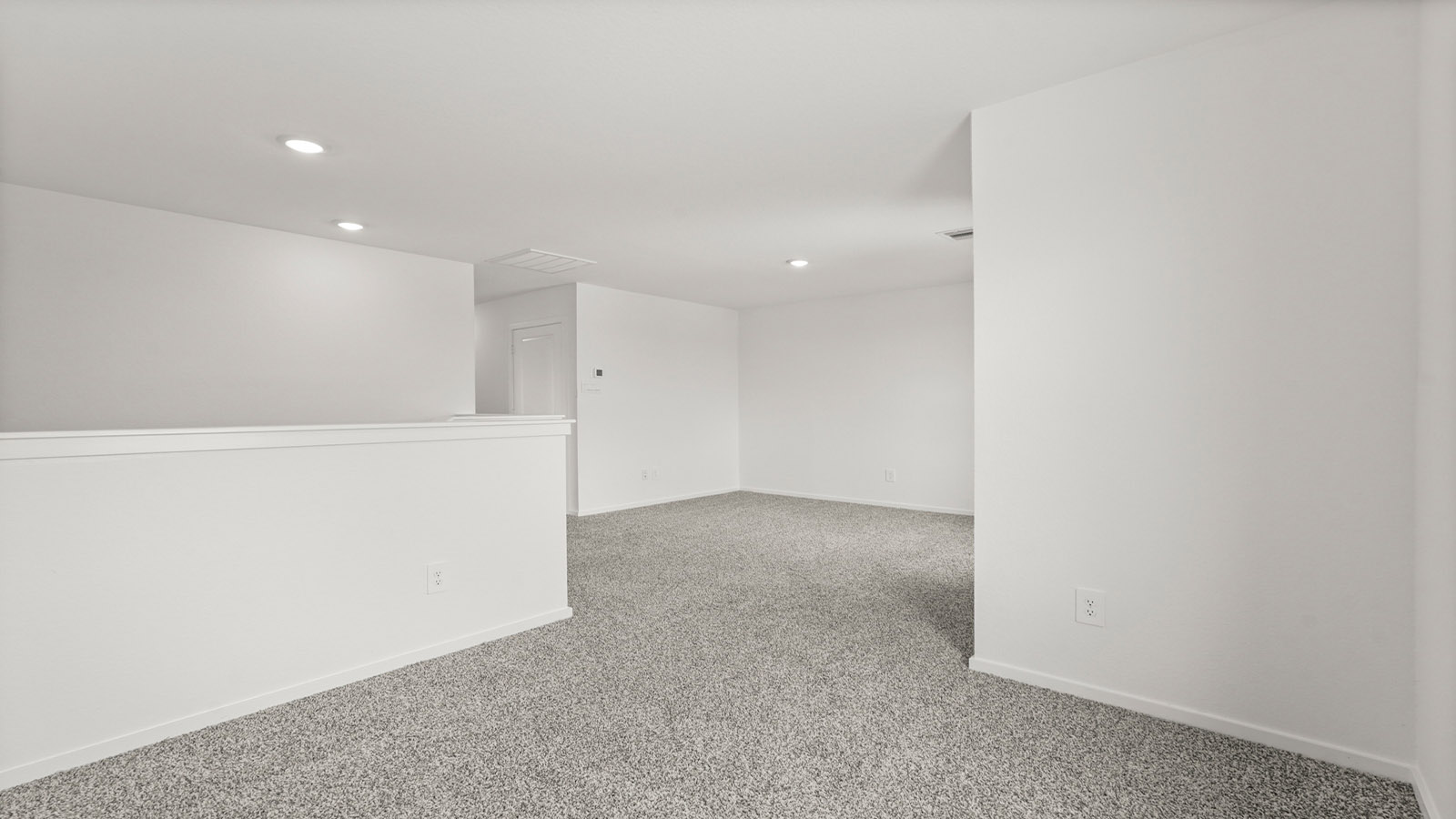 Second story game room with carpet flooring