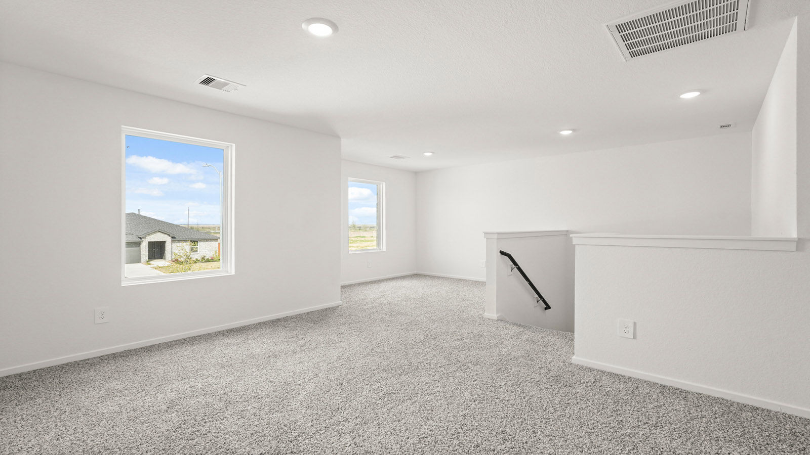 Second story game room with carpet flooring