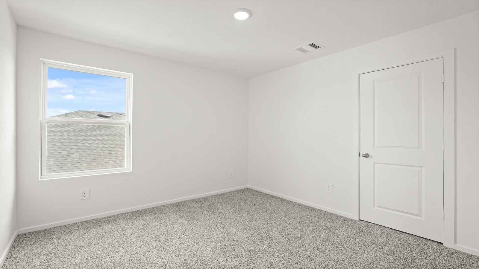 Secondary bedroom with carpet flooring