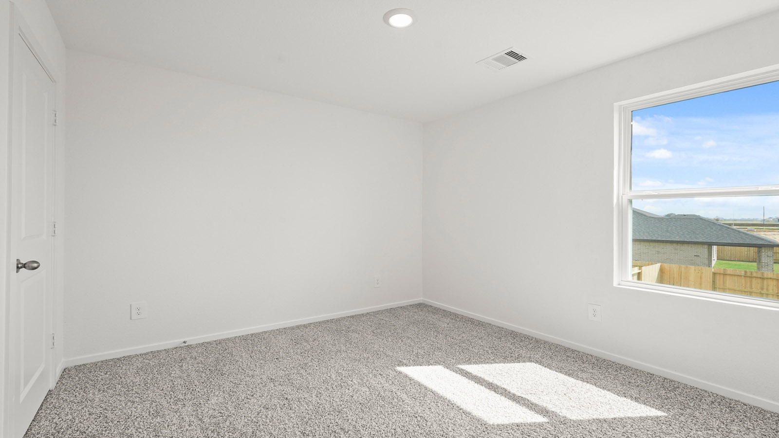 Secondary bedroom with carpet flooring
