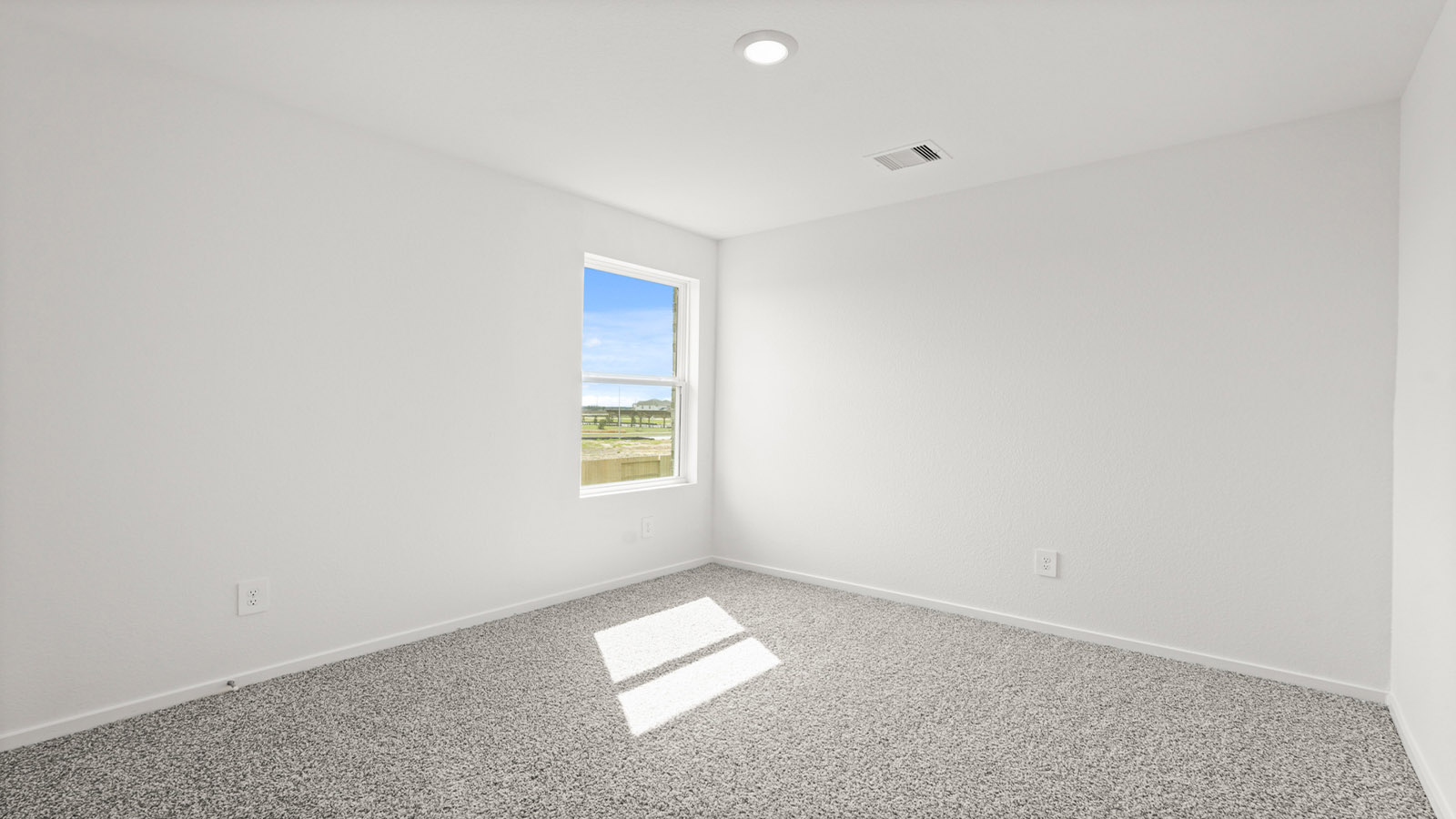 Secondary bedroom with carpet flooring