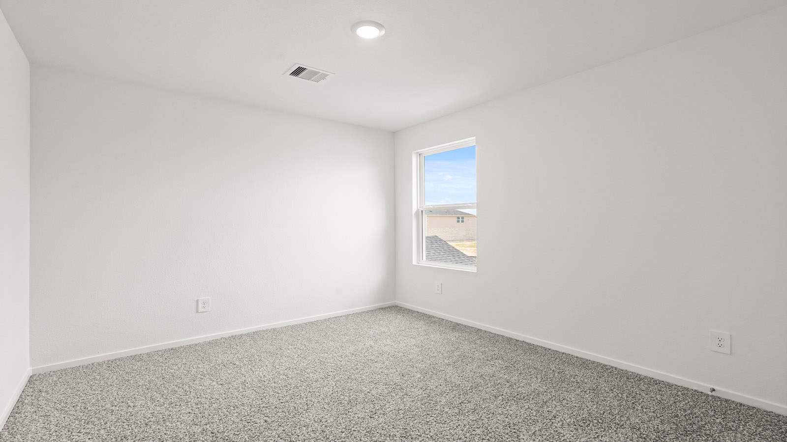 Secondary bedroom with carpet flooring