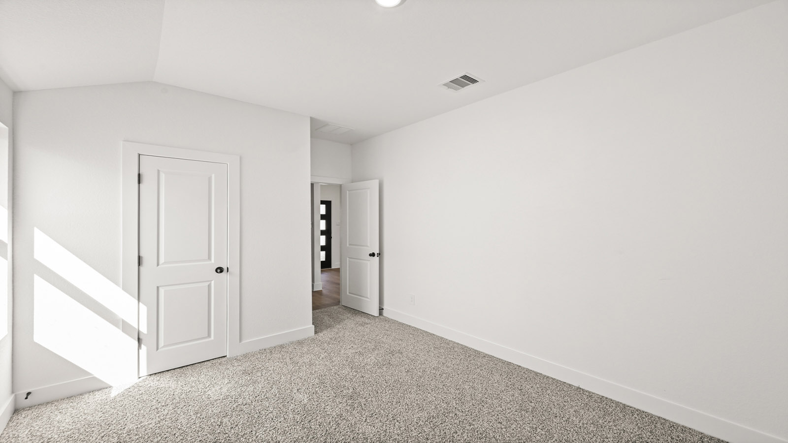 Secondary bedroom with carpet flooring