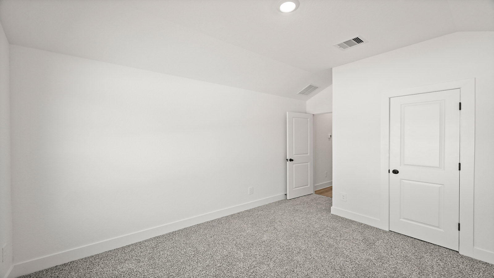 Secondary bedroom with carpet flooring