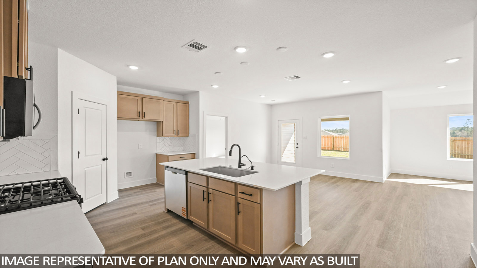 Kitchen with stainless steel appliances, quartz countertops and modern hardware and an island and vinyl floor