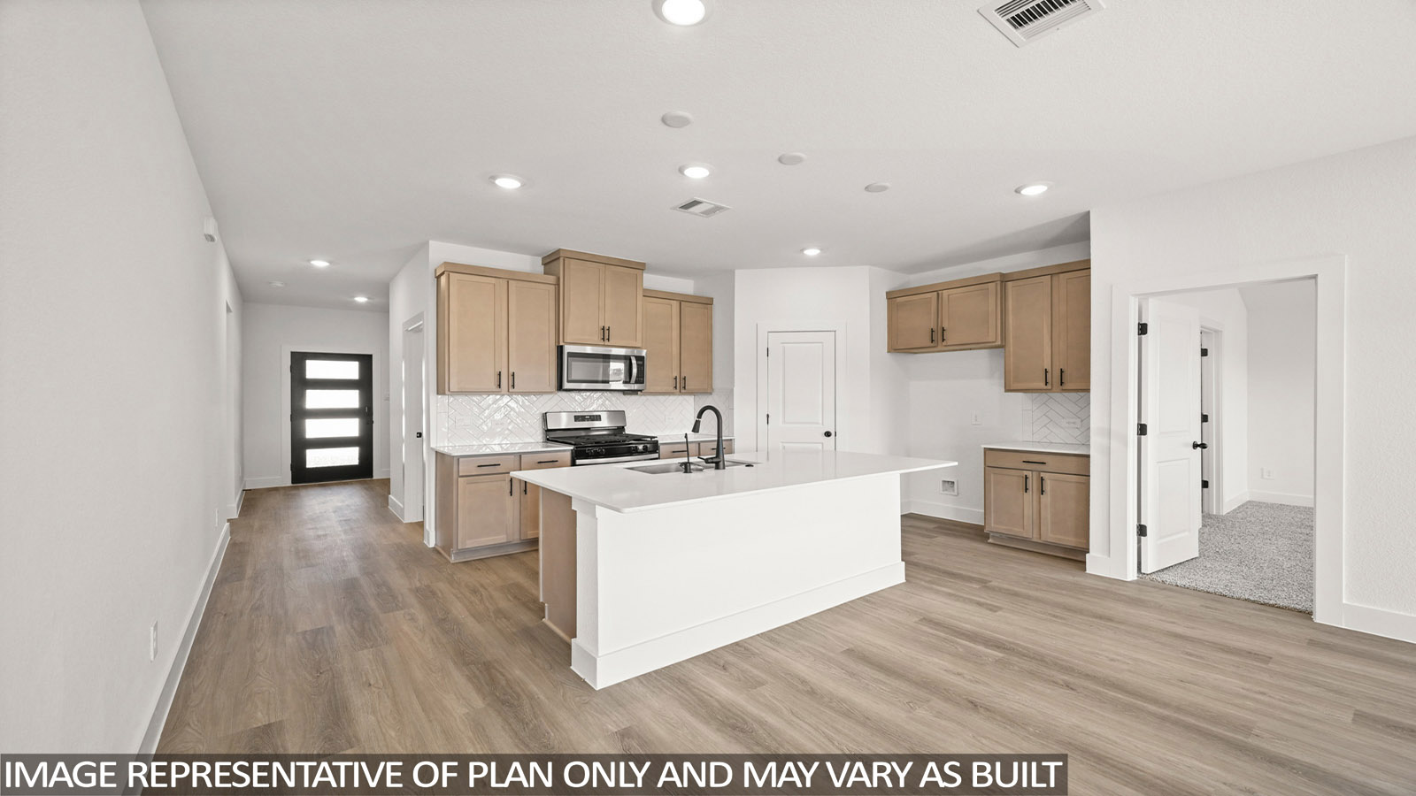 Kitchen with stainless steel appliances, quartz countertops and modern hardware and an island and vinyl floor