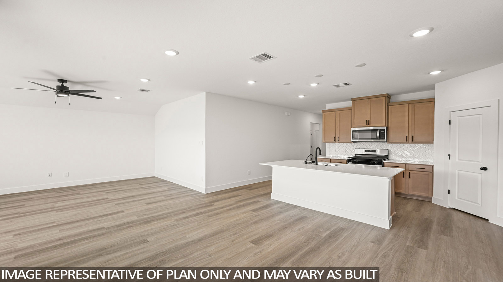 Kitchen with stainless steel appliances, quartz countertops and modern hardware and an island and vinyl floor