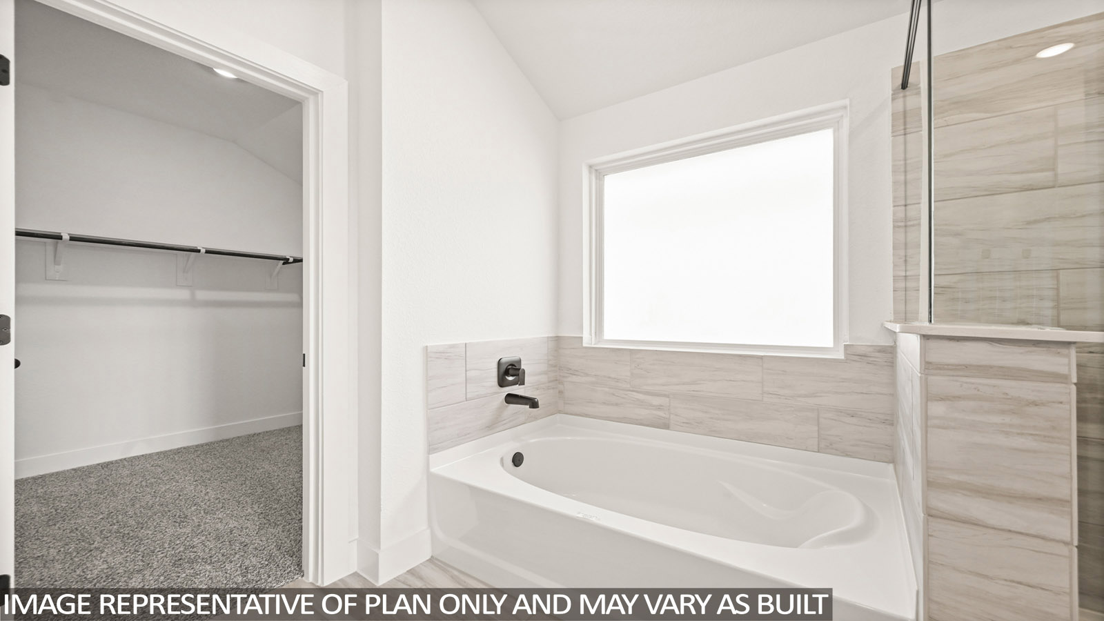 Primary bathroom with soaker tub and tile shower with semi frameless glass in Montgomery TX