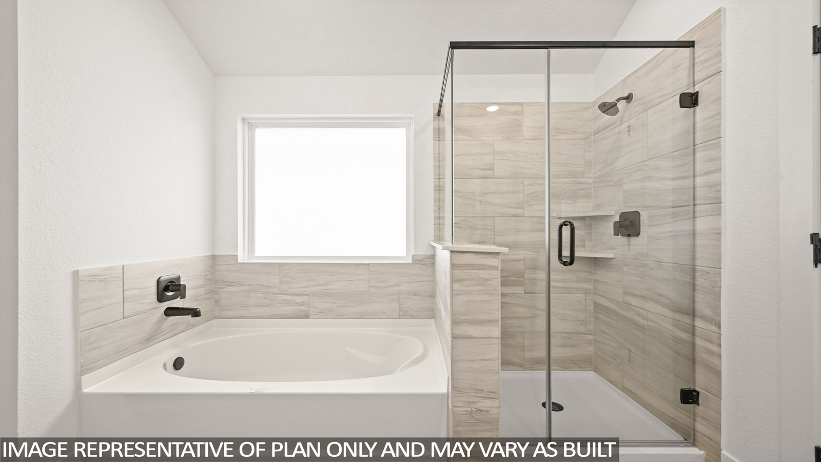 Primary bathroom with soaker tub and tile shower with semi frameless glass in Montgomery TX