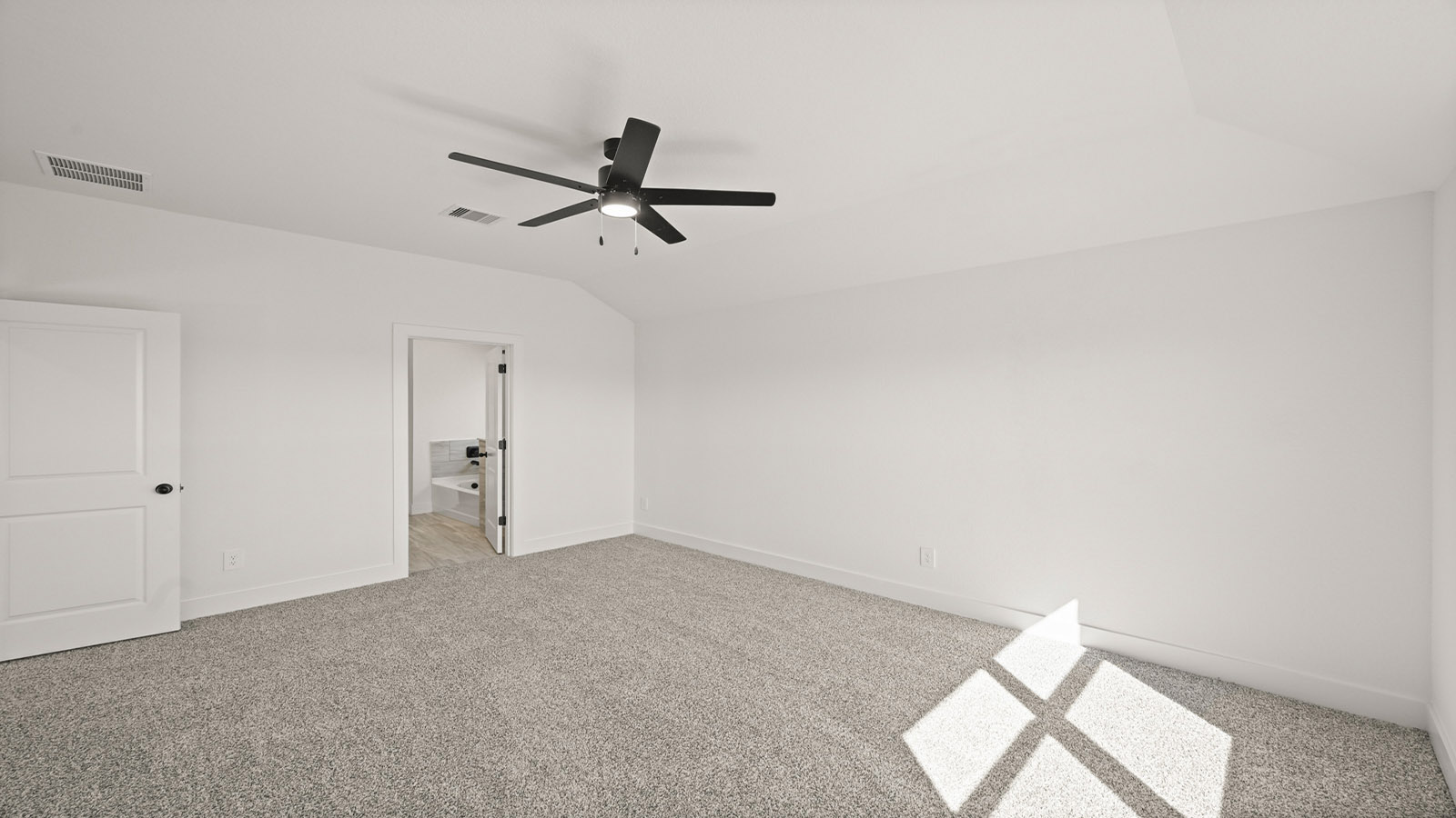 Primary bedroom with carpet flooring