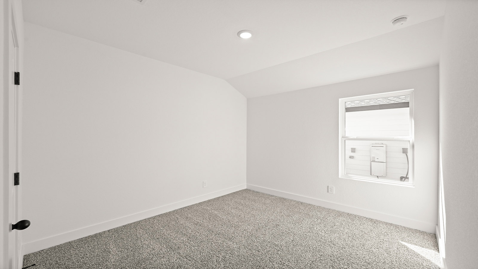 Secondary bedroom with carpet flooring