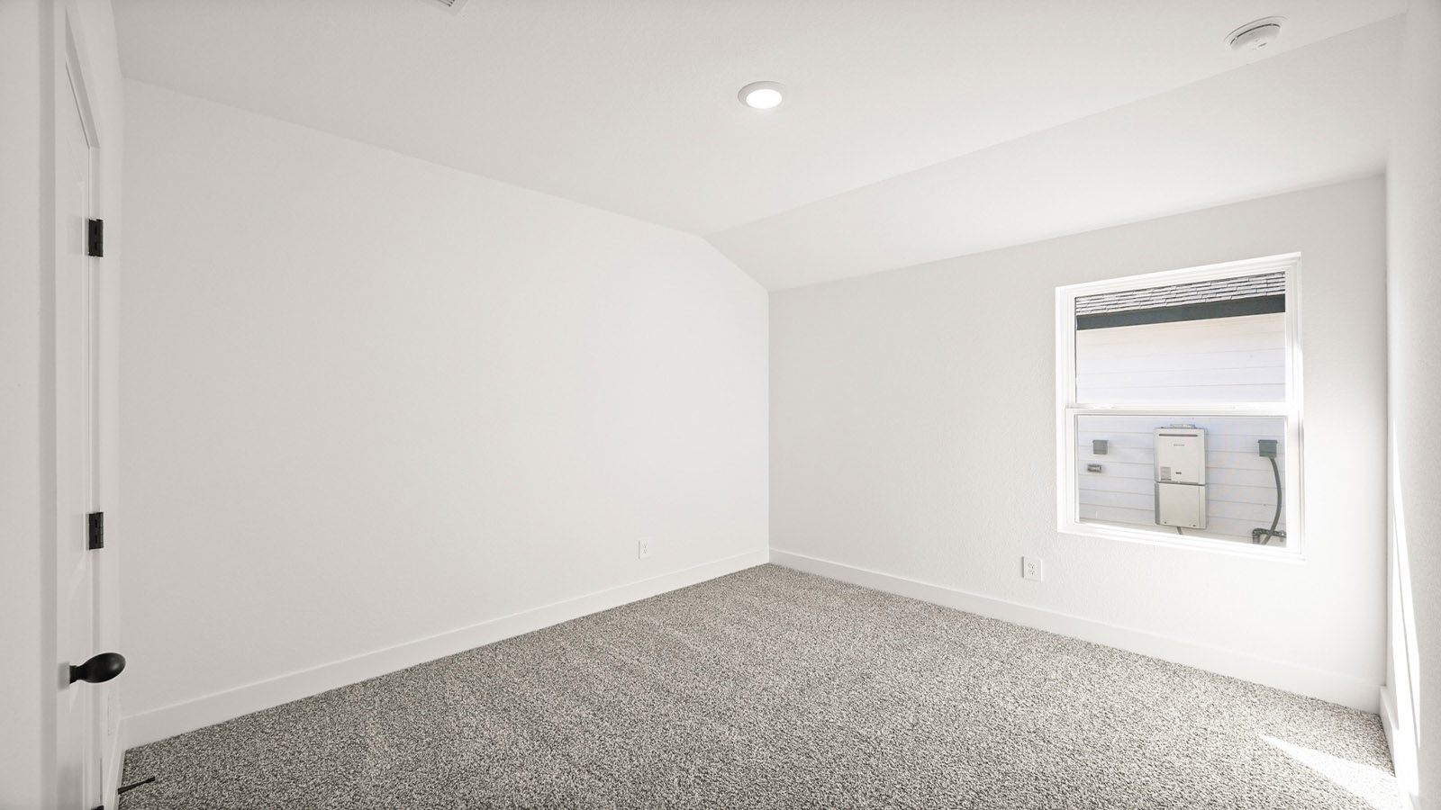 Secondary bedroom with carpet flooring