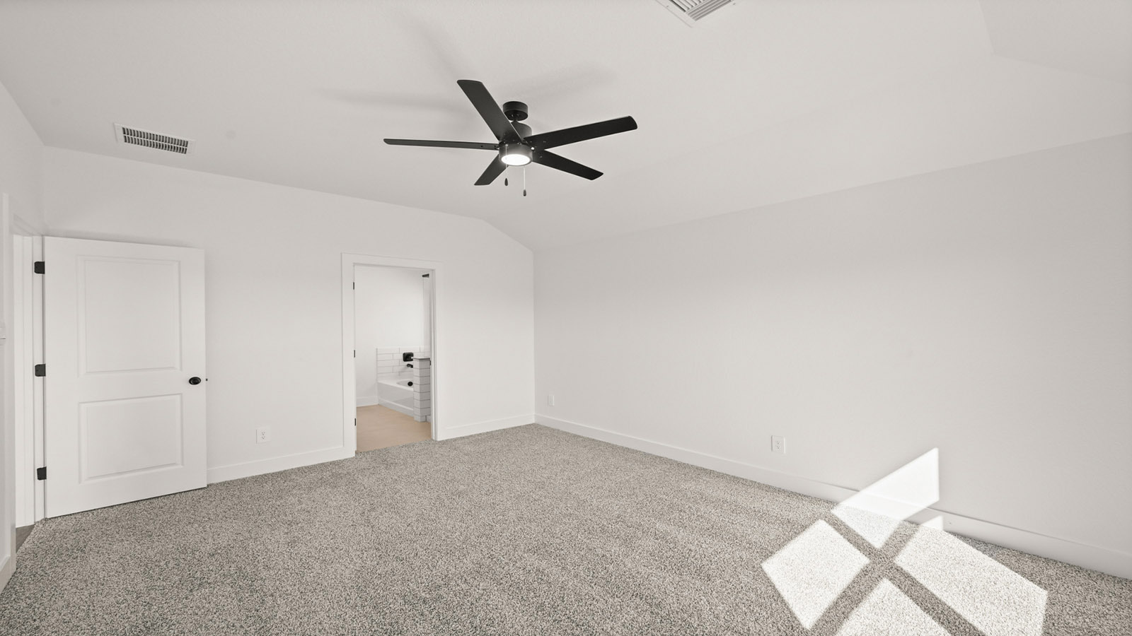 Primary bedroom with carpet flooring