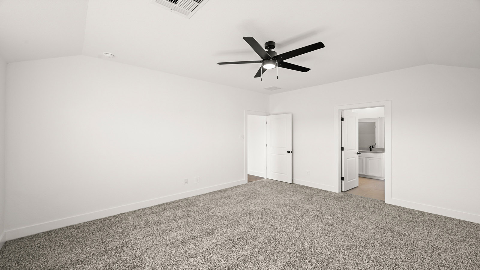 Primary bedroom with carpet flooring