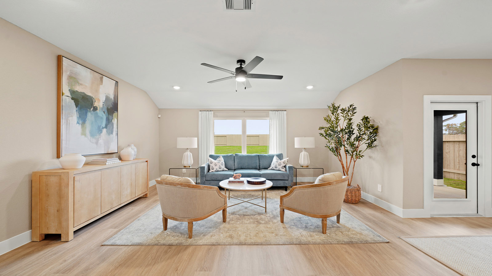Spacious living area with vinyl flooring
