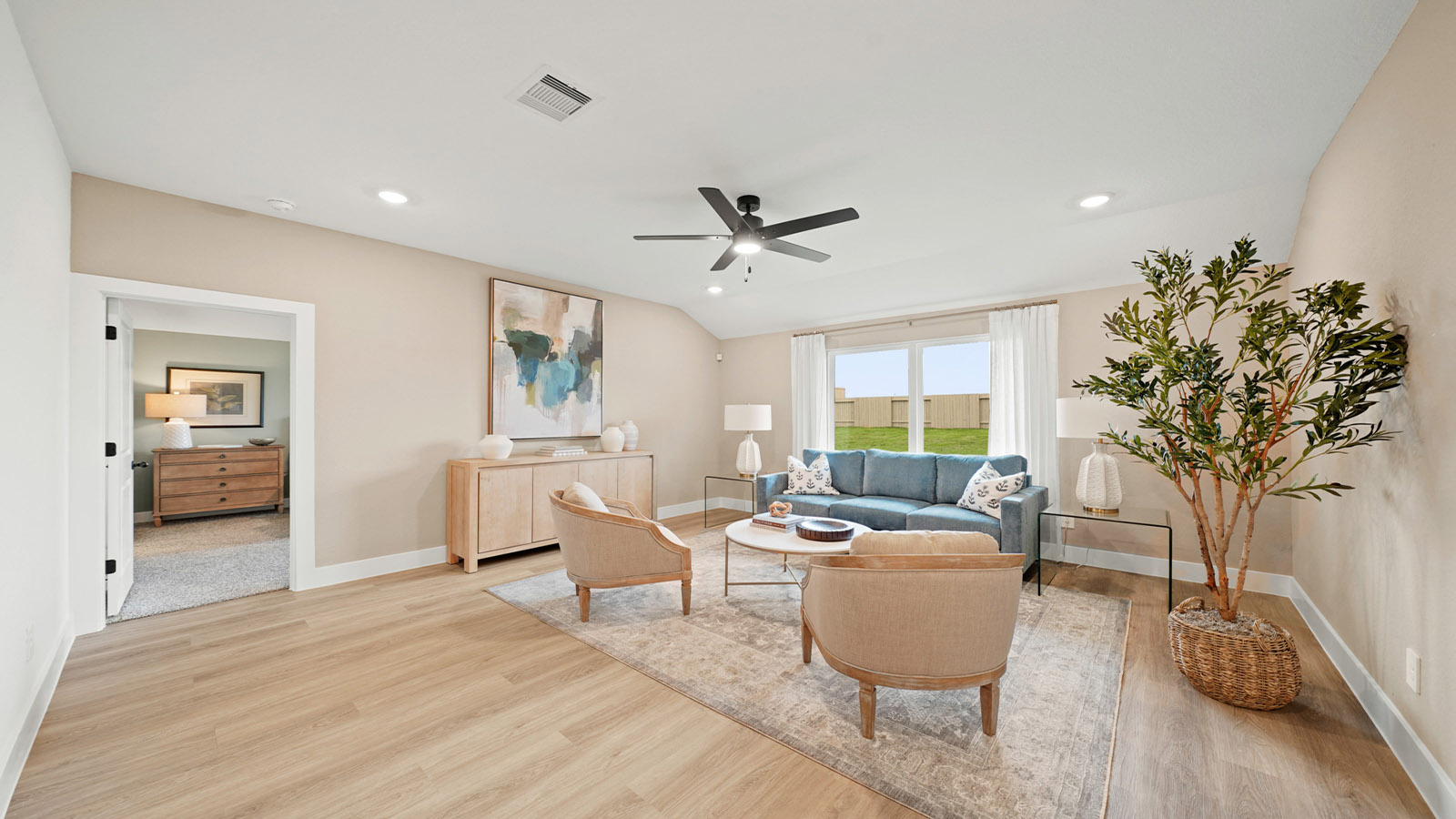 Spacious living area with vinyl flooring
