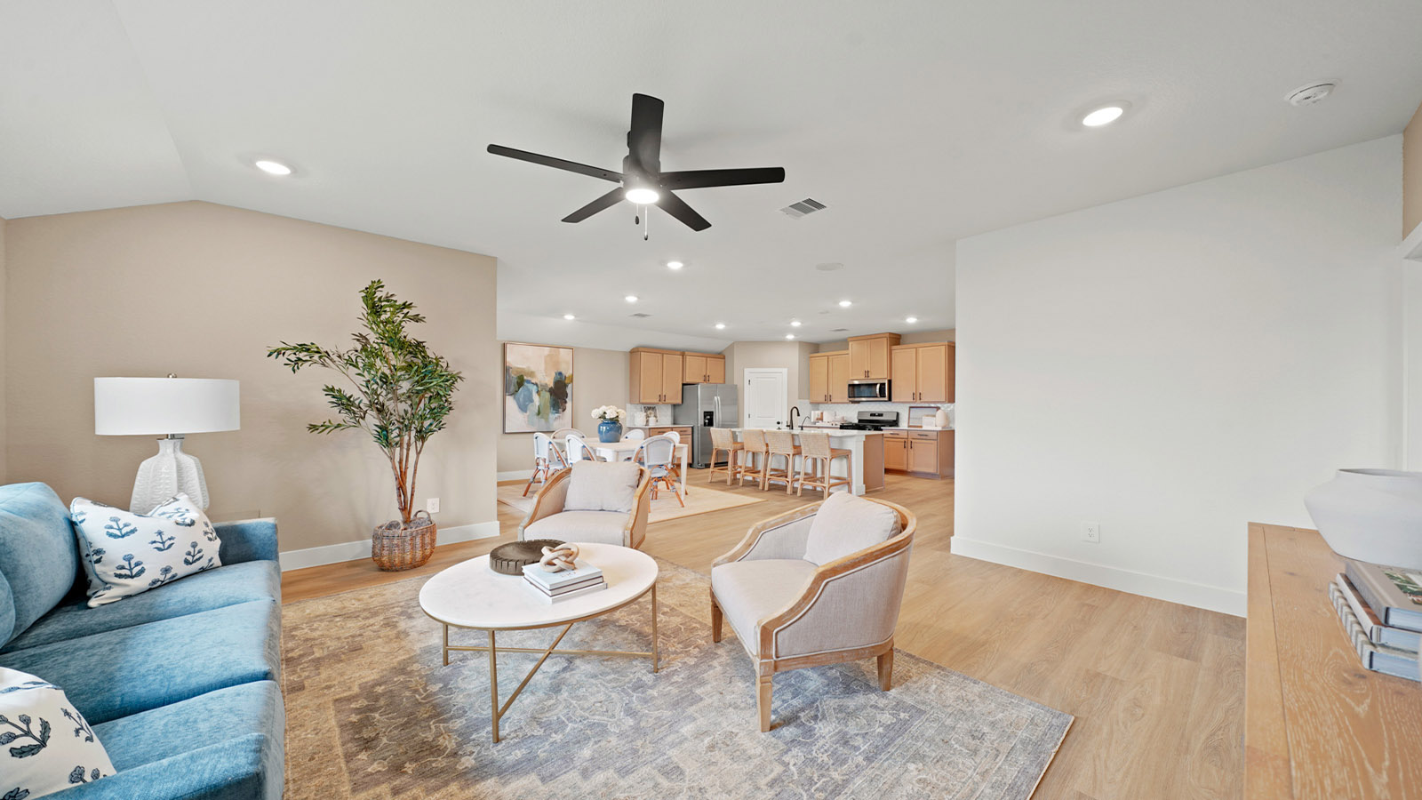 Spacious living area with vinyl flooring