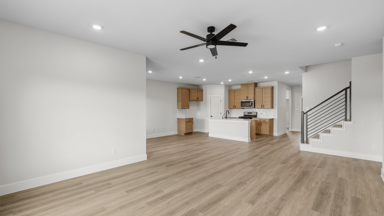 Spacious living area with vinyl flooring and bright windows in Montgomery TX