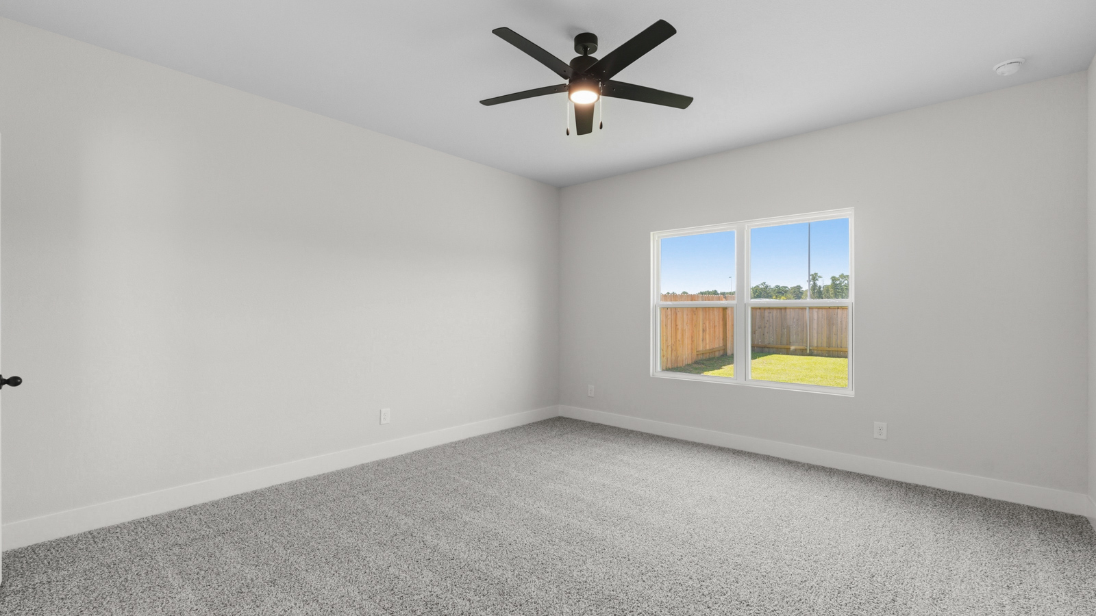 Large Primary bedroom with shag carpet flooring and bright window