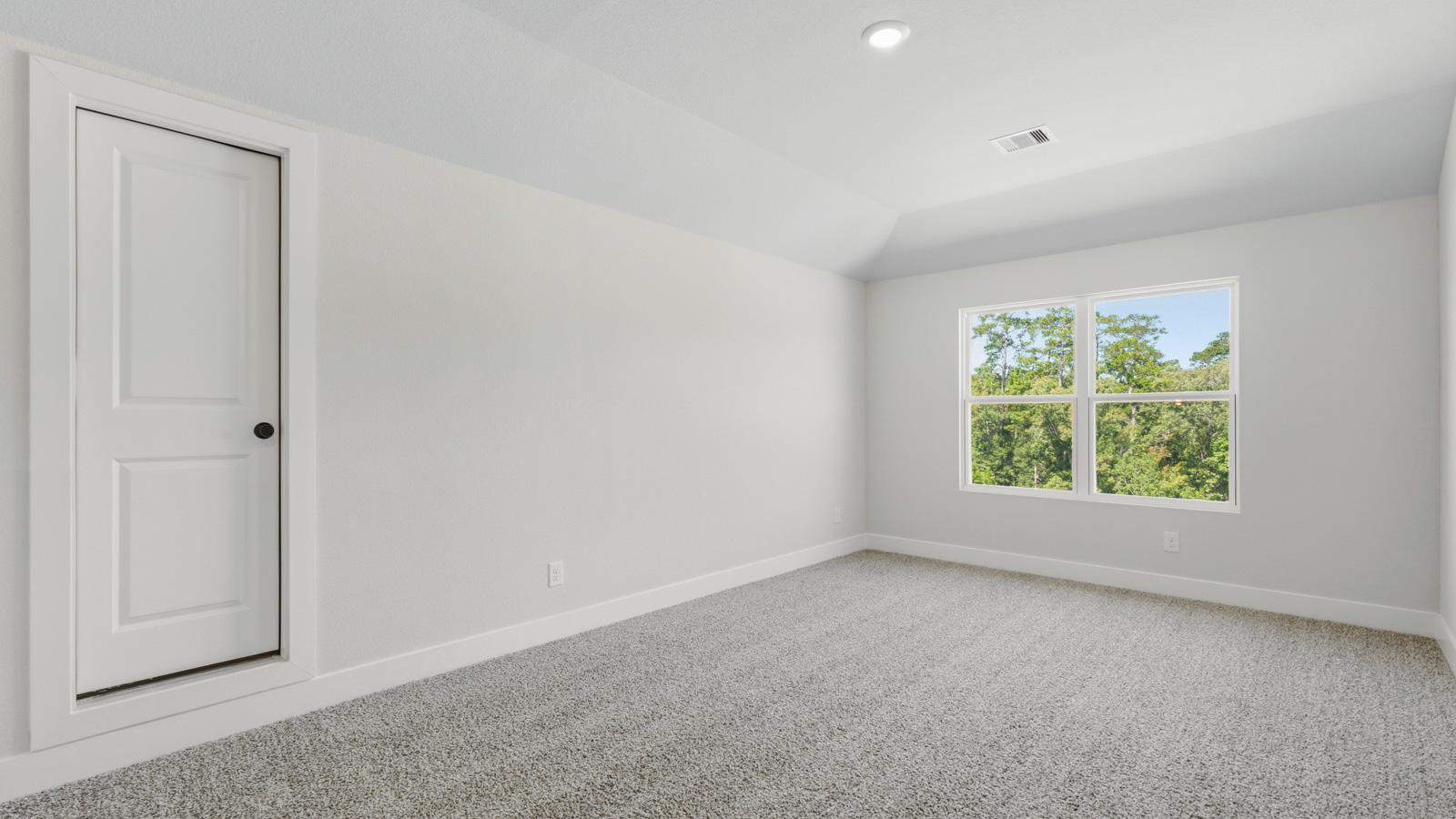 Second story game room with carpet flooring with bright windows in this multi functional space in Montgomery TX