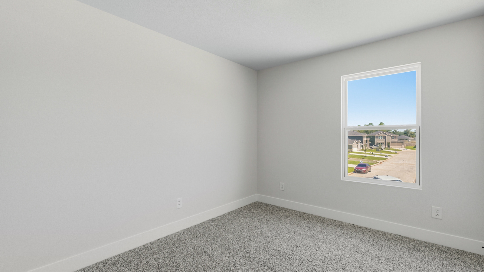 Secondary bedroom with shag carpet flooring and bright window