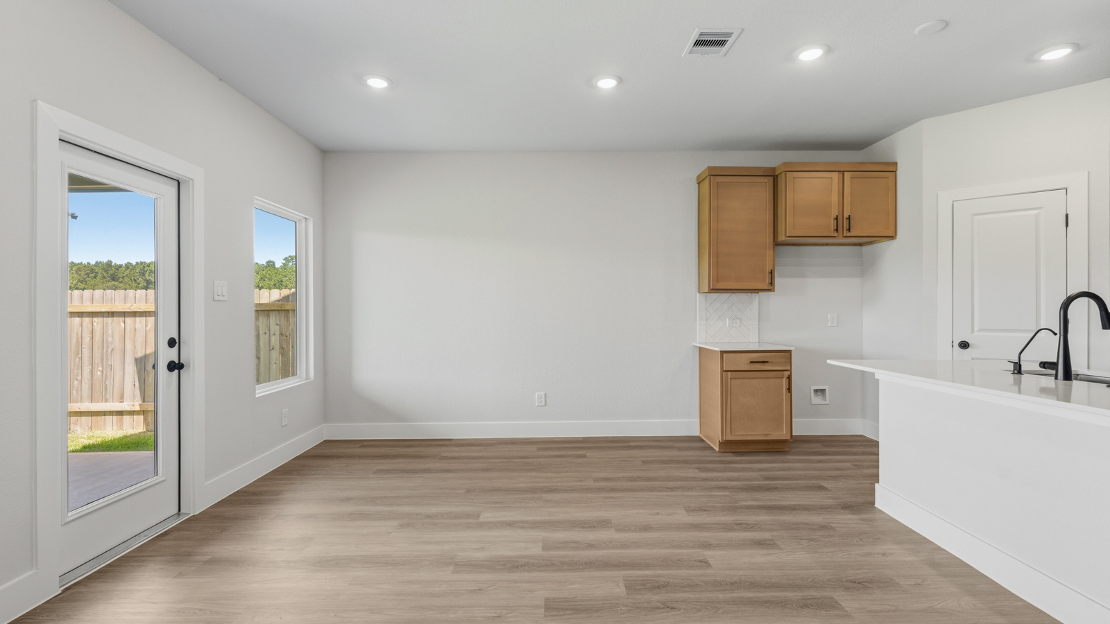 Dining area with vinyl flooring located off from the living room area in Montgomery TX