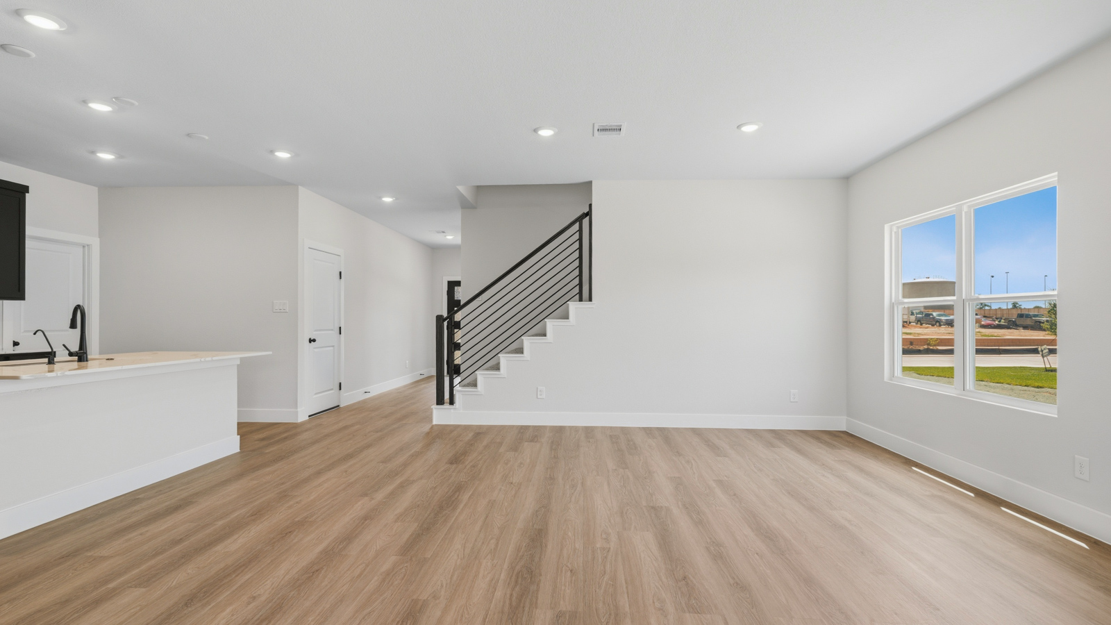 Spacious living area with vinyl flooring and bright windows in Montgomery TX