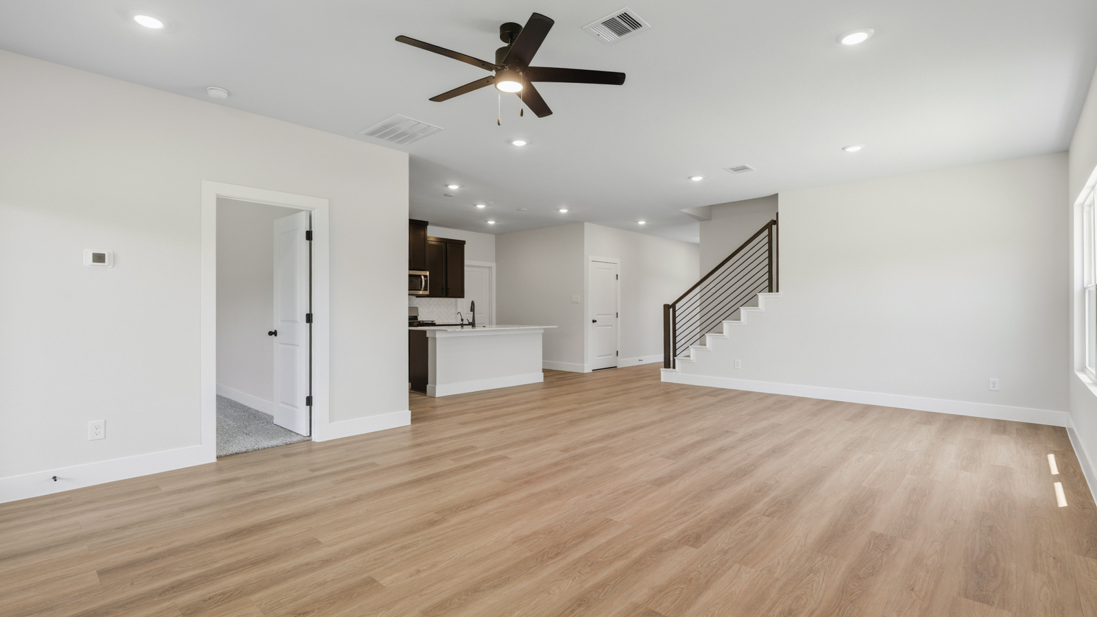 Spacious living area with vinyl flooring and bright windows in Montgomery TX