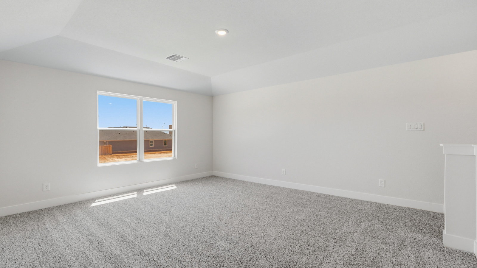 Second story game room with carpet flooring with bright windows in this multi functional space in Montgomery TX