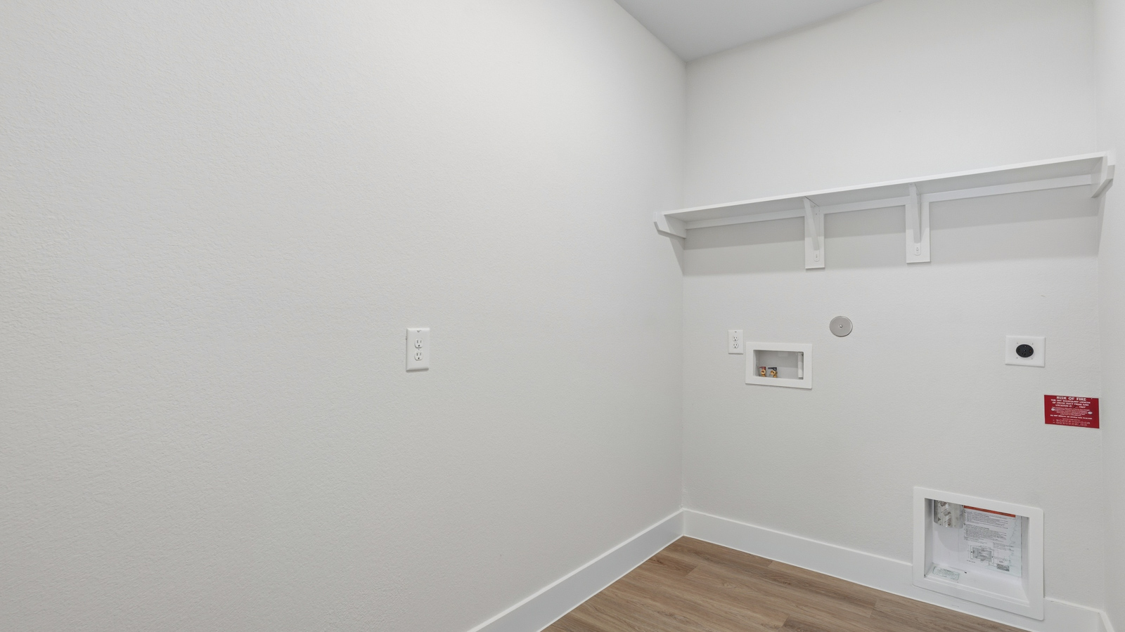 Utility room with storage located off the entry hallway and garage door