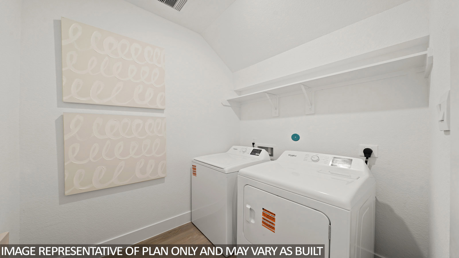Utility room with storage located off the entry hallway and garage door