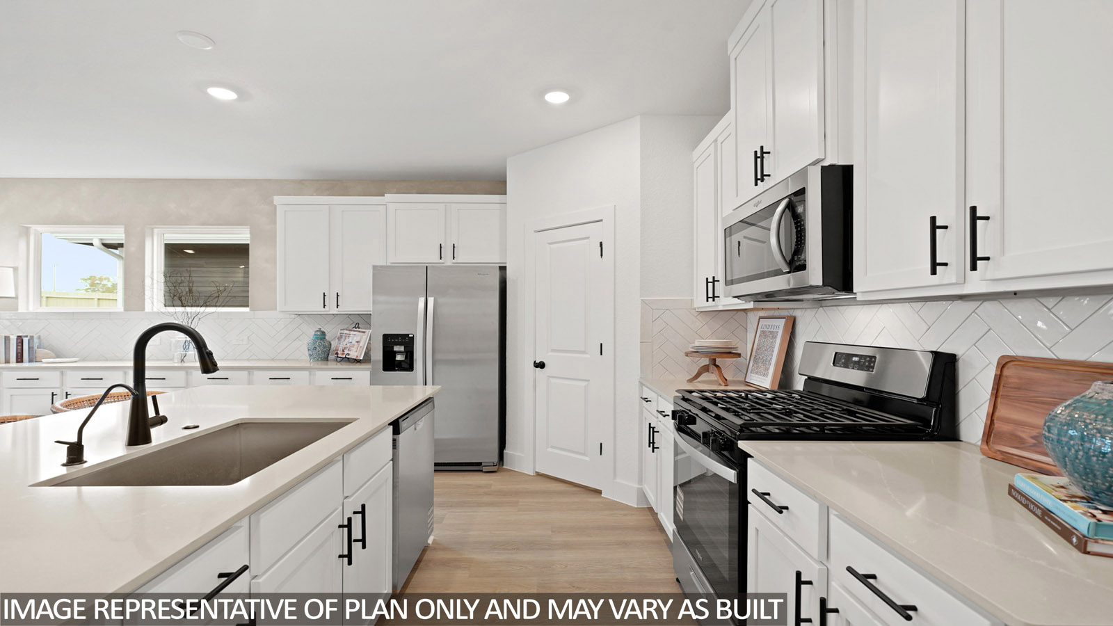 Kitchen with stainless steel appliances, quartz countertops and modern hardware and an island and vinyl floor
