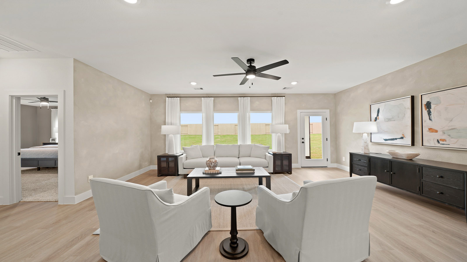 Spacious living area with vinyl flooring