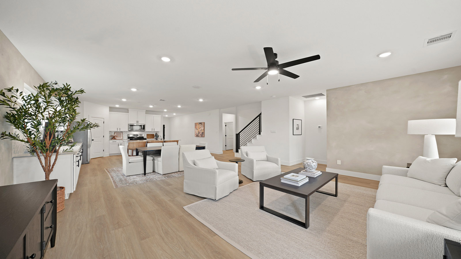 Spacious living area with vinyl flooring