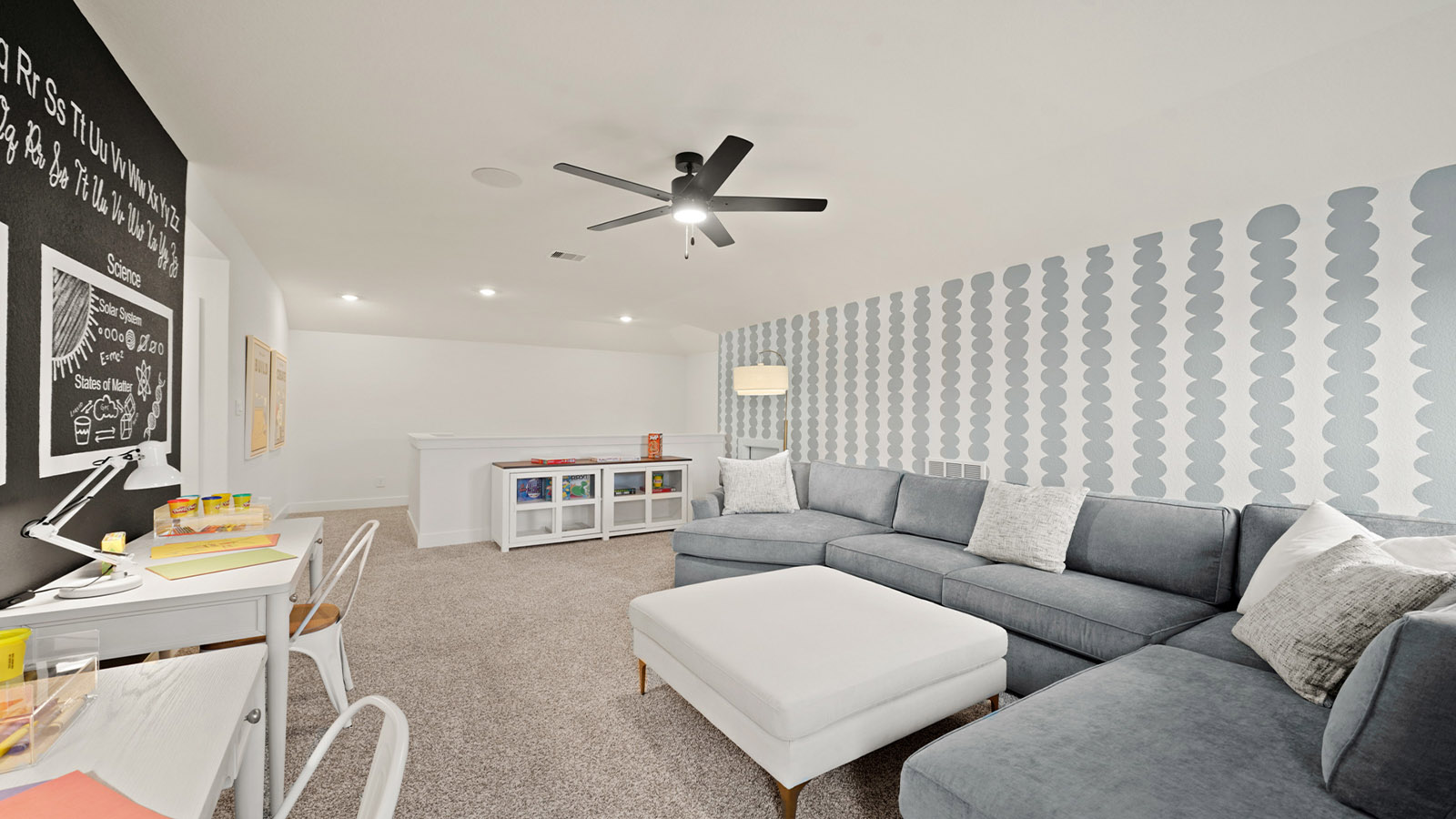 Second story game room with carpet flooring