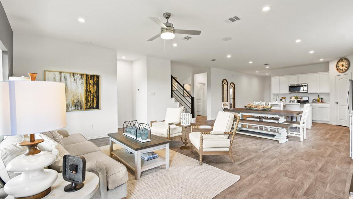 open concept living and dining area with vinyl flooring and large windows
